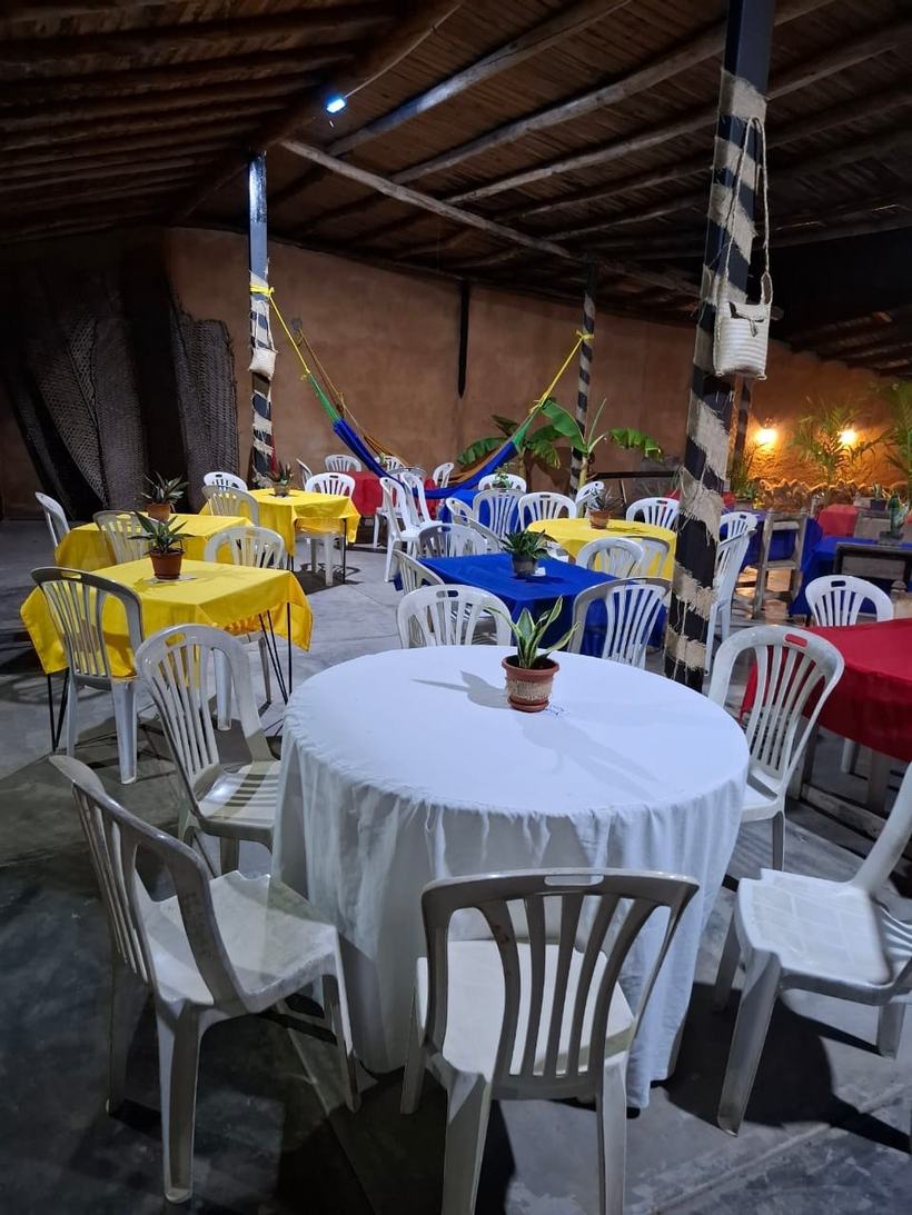 Mesas con manteles, sillas y hamacas en la terraza